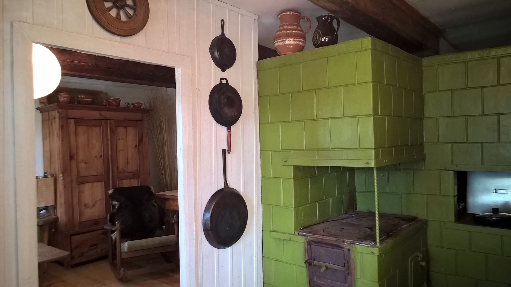 Old farmhouse interior with a green tiled stove
